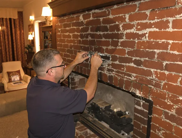 Wilmington Chimney Sweep expert fixing a fireplace in Wilmington, MA